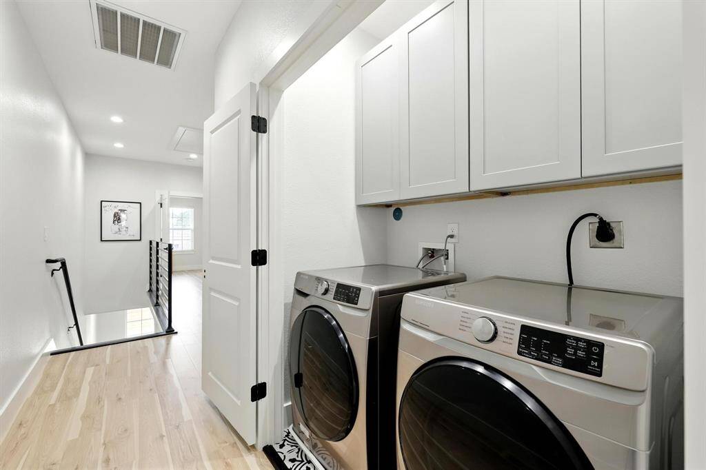 Just off the landing is a convenient second-floor laundry room, complete with built in cabinets.