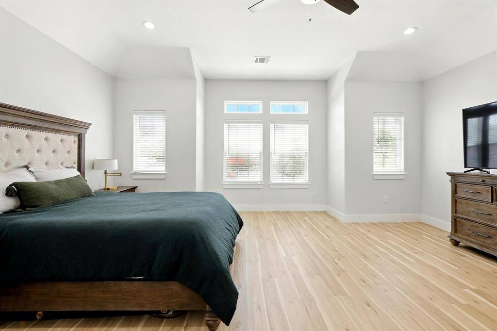 The primary bedroom offers a true retreat offering generous square footage that easily accommodates more than just a bed. There's enough space for a cozy sitting area with a couch, a desk, or a quiet reading corner.