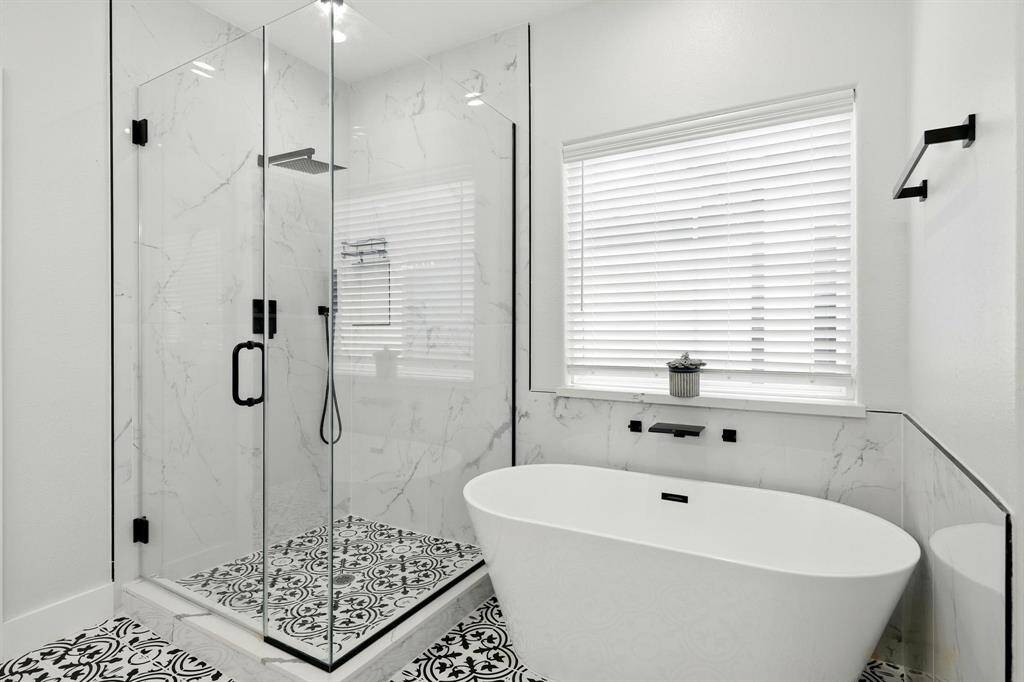 Free standing soak tub and separate glass enclosed  shower.