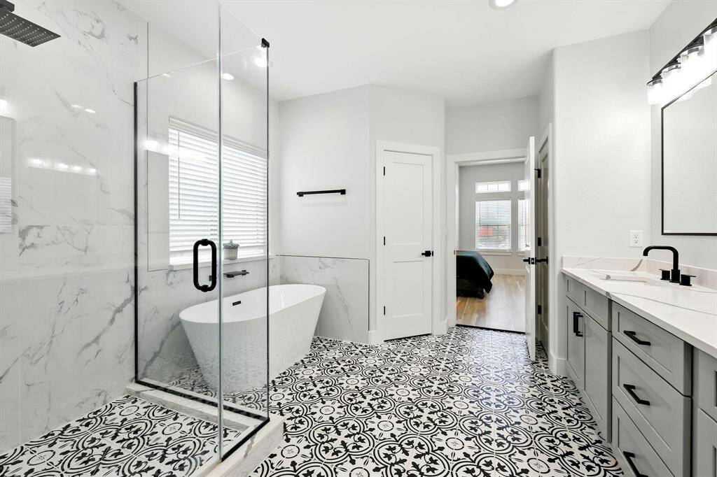 The primary bathroom offers ample space for relaxation!