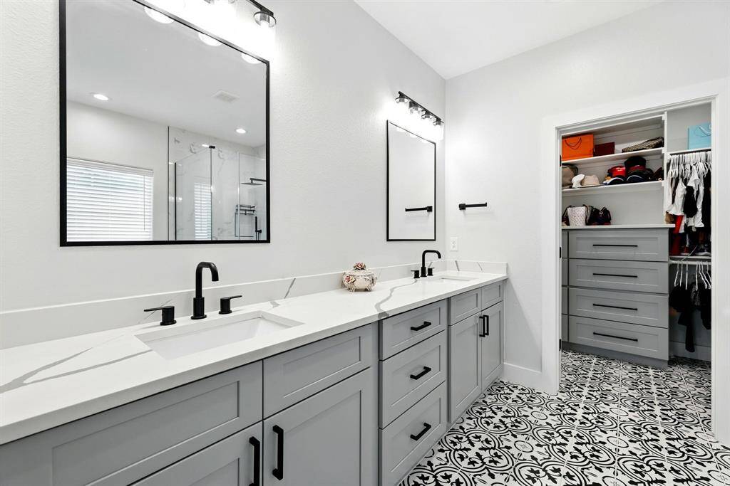 This home features double sinks in both the primary and secondary bathrooms offering added convenience for busy mornings and a touch of everyday luxury with sleek, modern fixtures and plenty of counterspace.