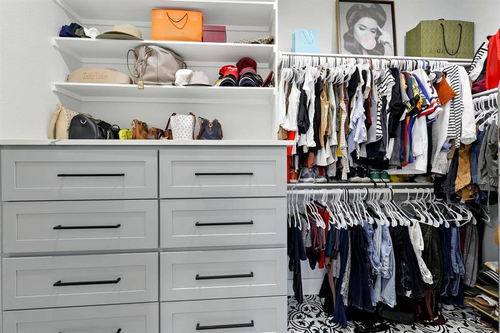 Primary bedroom also features a walk-in closet with custom shelving and storage solutions to keep everything organized and accessible.