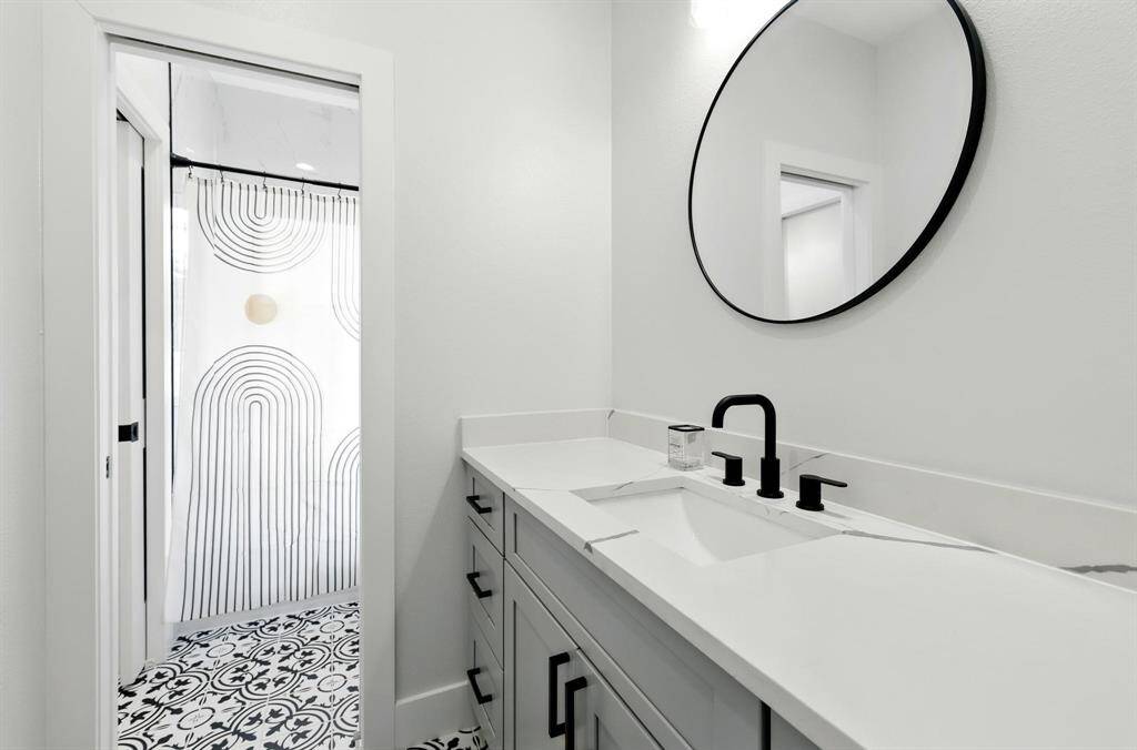 The second full bathroom is thoughtfully designed with both style and functionality in mind. It features double separate sinks, each with its own vanity space ideal for shared use without sacrificing personal comfort.