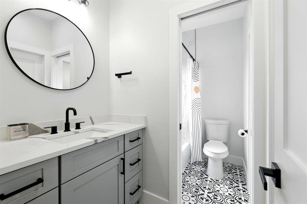 Separate sink space, quarts countertops add a sleek, modern touch, contemporary fixtures, and ample storage beneath.