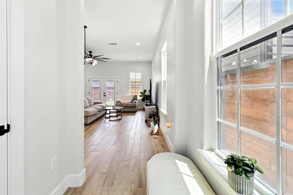 Step inside the entry way into a spacious open-concept family living room and kitchen layout, perfect blending style and function with an abundance of natural light that instantly creates a sense of space and serenity.