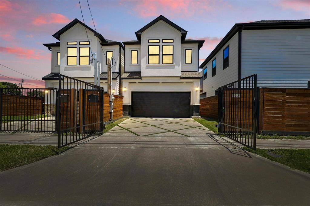This home features a mix of textures with accent lighting that captures its sharp angles and clean sleek curb appeal.