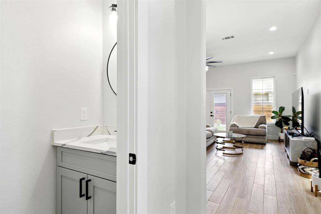 Stylish first-floor half bath perfectly positioned for guests and everyday convenience.
