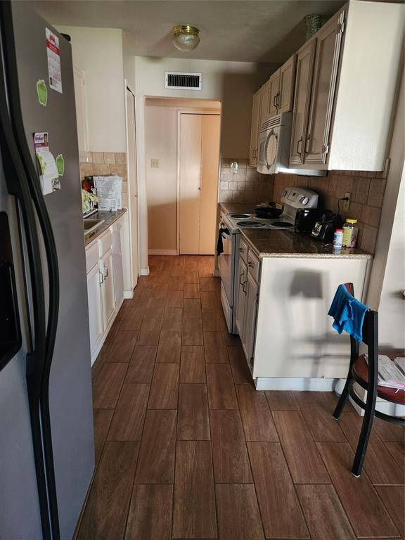 View of Kitchen features Ceramic Tile Floor and Granite Countertops