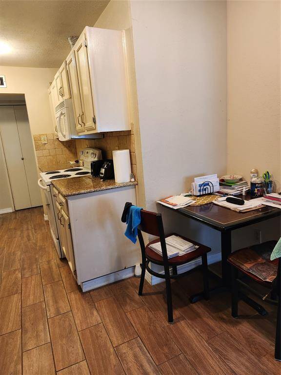 Breakfast nook being used as an office area. Nice Granite CounterTops and Ceramic Tile Floor