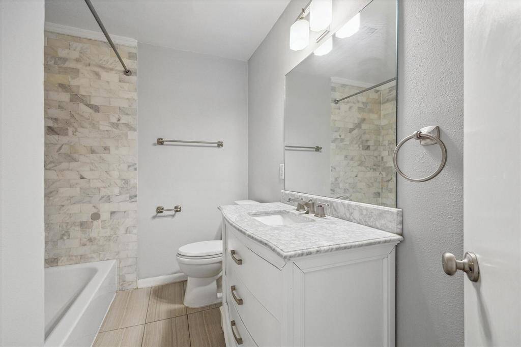 Hall bath with tub/shower combo.
