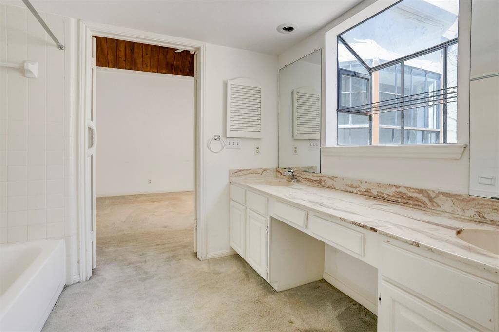 The primary bath has double sinks and a vanity area.