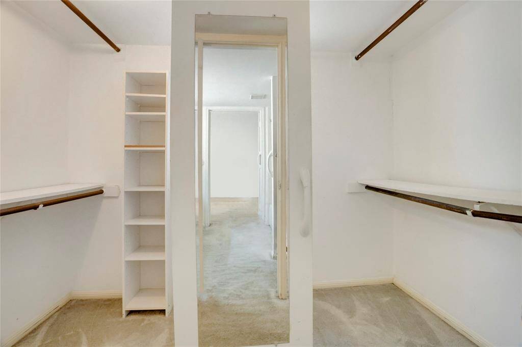 The walk in primary closet has ample built ins.