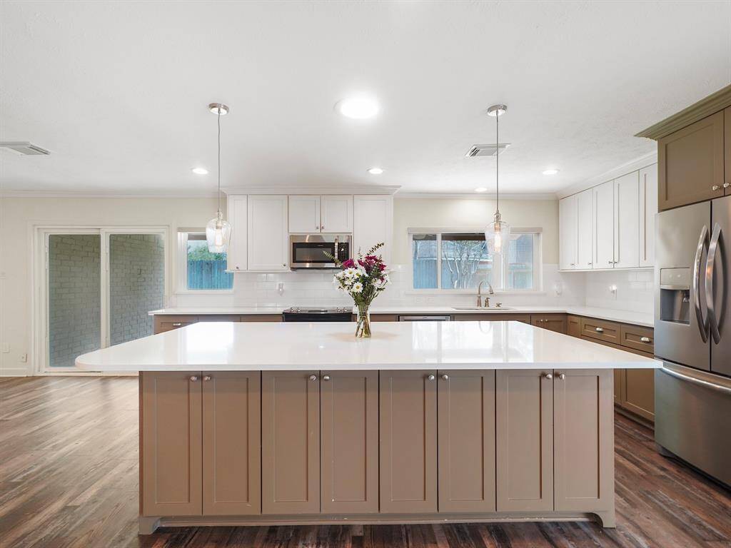 Dream kitchen alert! This home boasts a stunning custom island offering ample storage, complemented by sleek custom cabinetry and elegant recessed lighting.