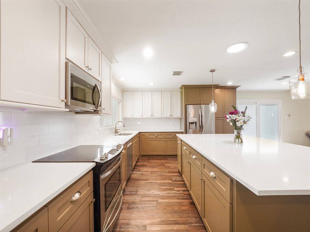 The heart of this home is undoubtedly its exquisite kitchen, featuring a beautifully crafted custom island with generous under-counter storage
