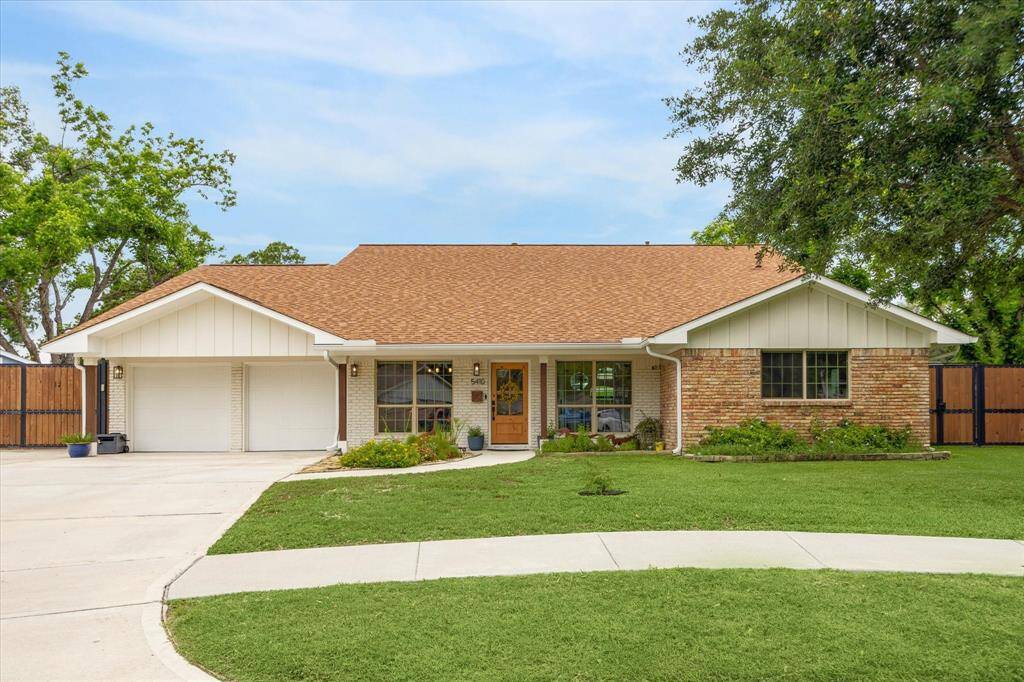 Front façade with attached garage and spacious lawn.