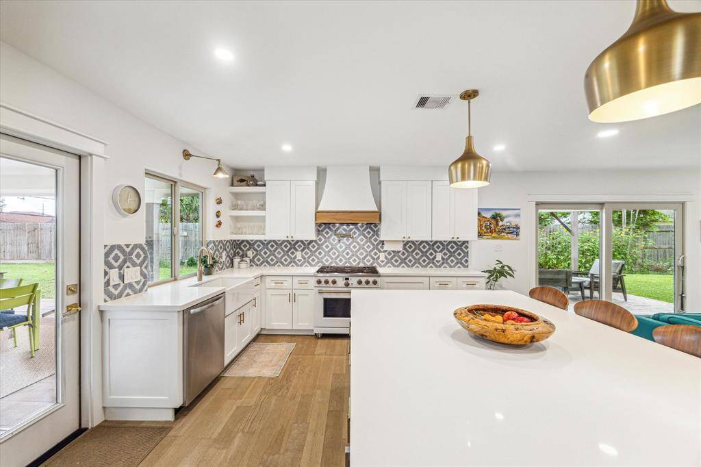Clean, modern kitchen featuring stainless steel appliances and a spacious island.