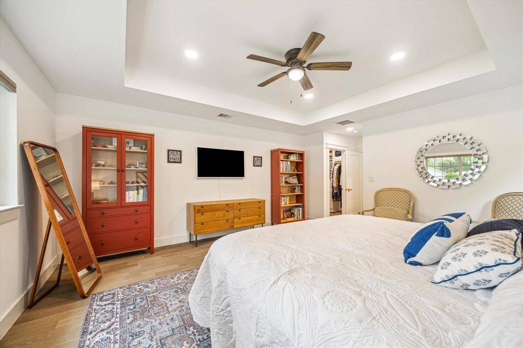 Inviting primary bedroom with bright, airy ambiance and tidy layout.