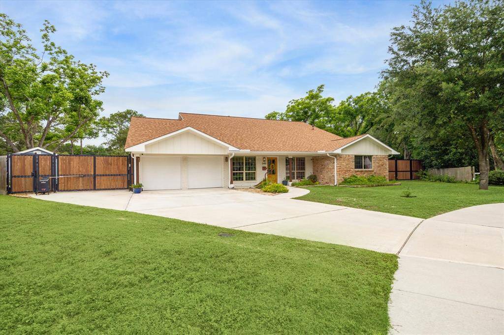 Exterior shot showing the attached garage, driveway and well-kept lawn.