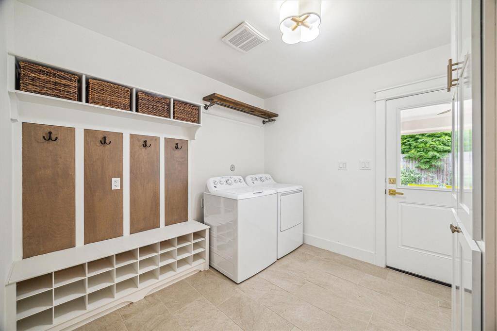 Spacious and bright laundry area with practical wall shelving.