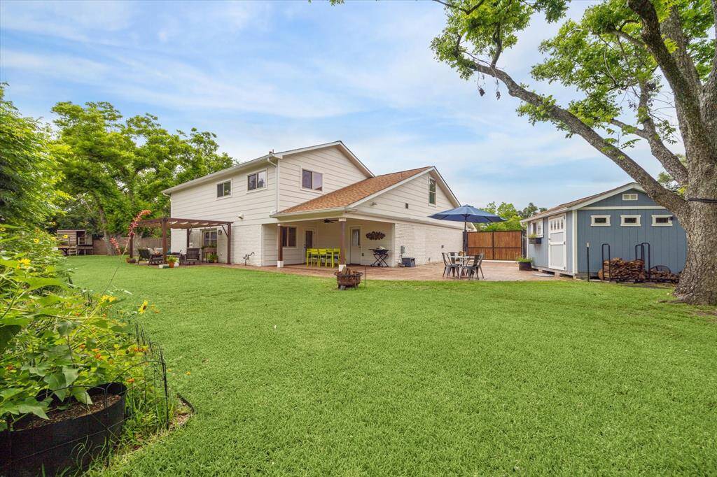 Neat, spacious backyard with a covered patio for outdoor relaxation.