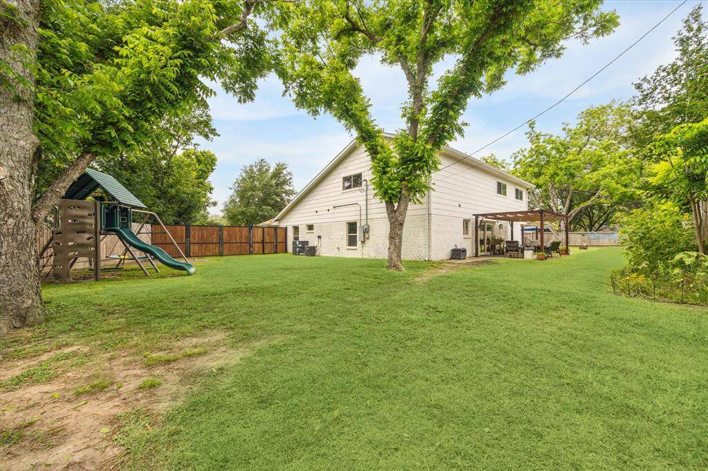 Well-maintained backyard featuring a covered patio and ample space.