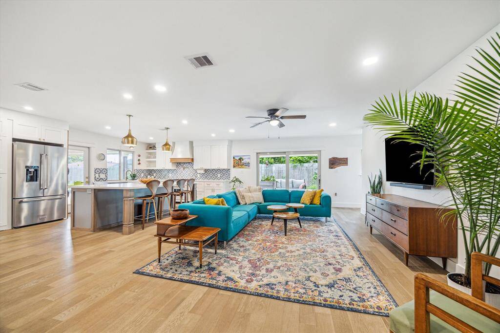 Open-concept kitchen and living area filled with natural light.