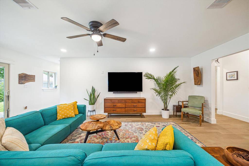Large living space offering a warm, sunlit atmosphere.