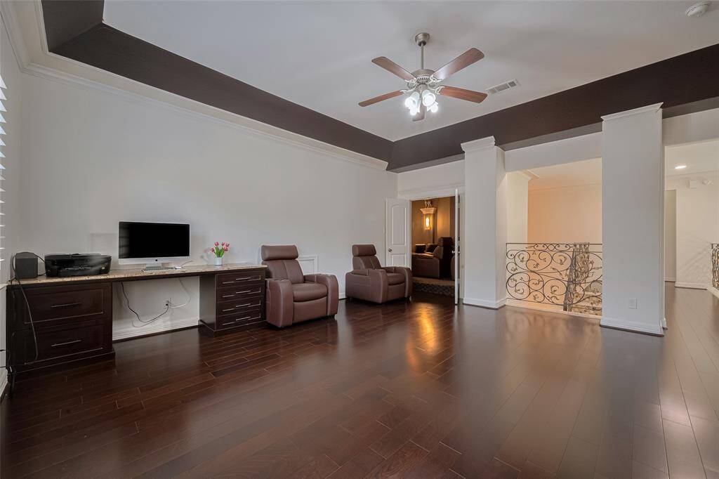 Upstairs, enjoy wood flooring throughout the second level of the home and a game room with custom built-ins cabinets for storage and workspace.