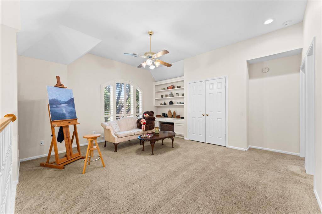 The upstairs gameroom with generous closet and built in desk with shelves.
