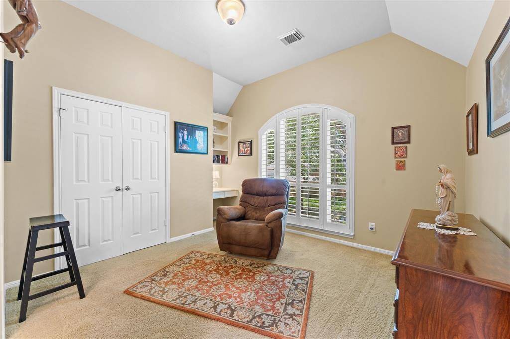 Bedroom 3 has a built-in desk and a pretty, arched window.