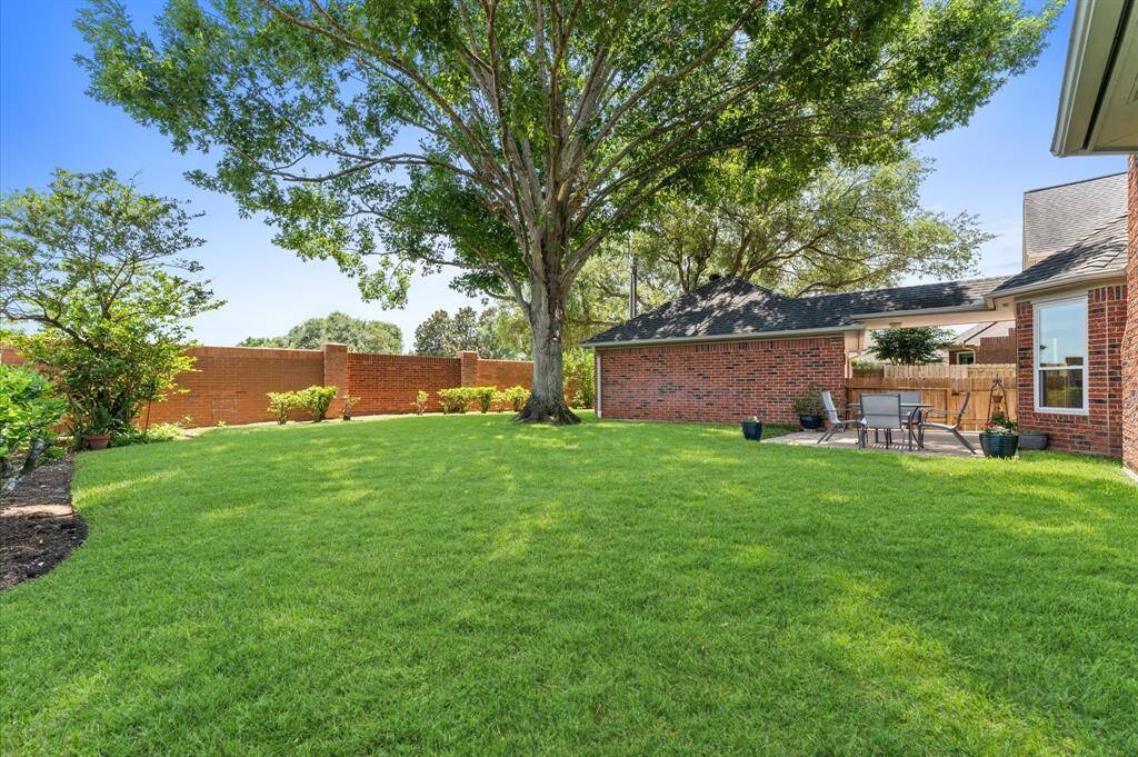 The backyard is so lovely and has a brick fence that is maintained by the HOA.
