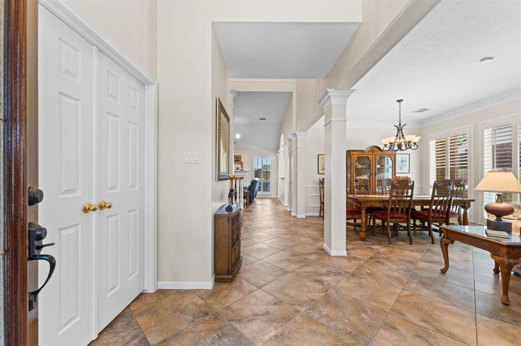 The foyer opens to formal living and dining rooms.