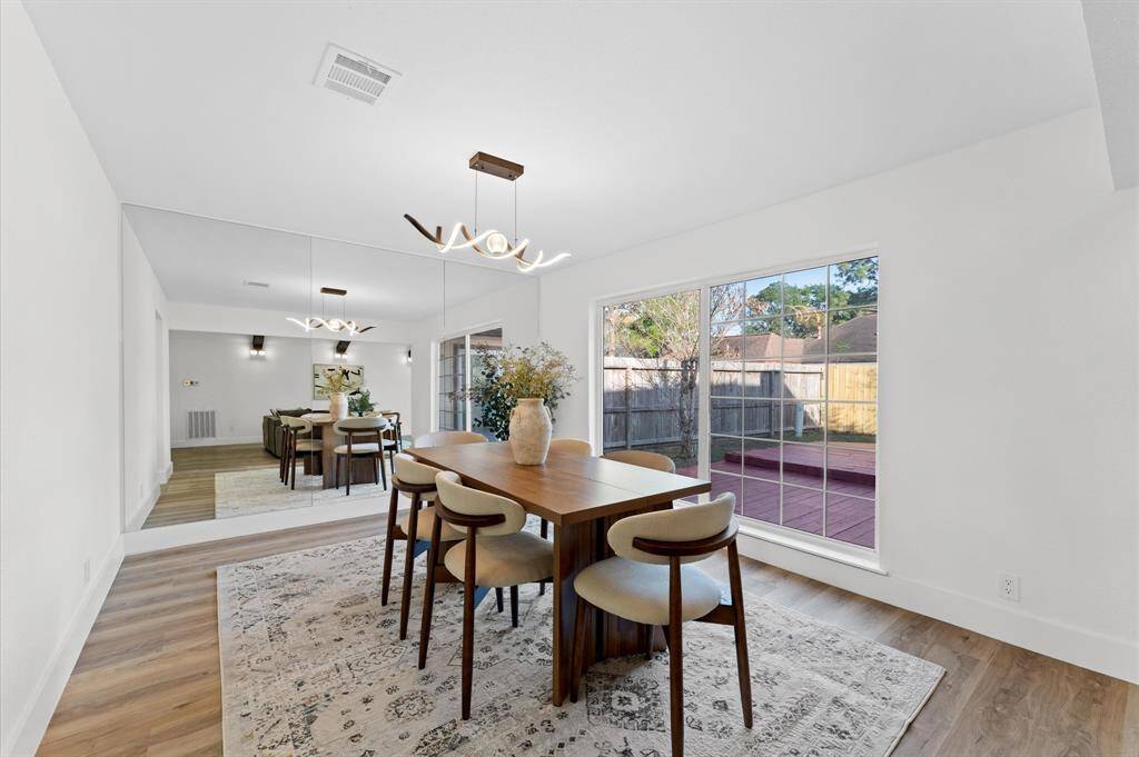 Expansive dining area with plenty of natural light and beautiful views of the patio, creating the perfect space for family meals and gatherings.