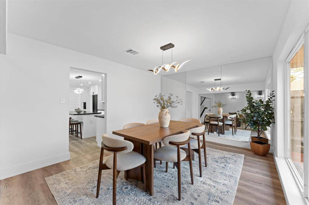 Expansive dining area with plenty of natural light and beautiful views of the patio, creating the perfect space for family meals and gatherings.