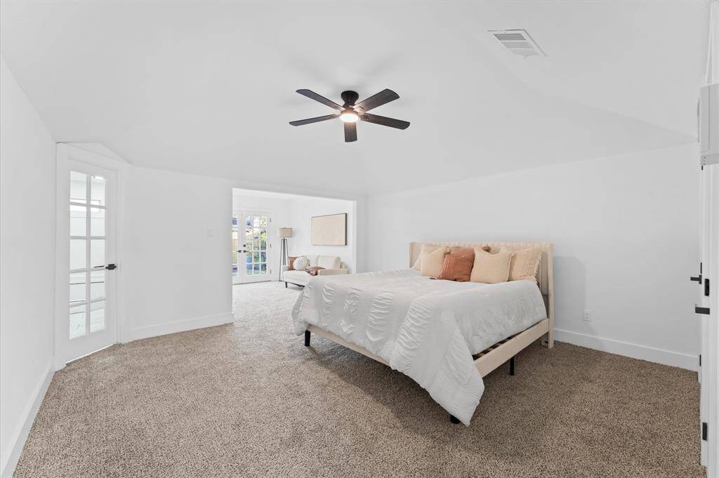 Expansive primary suite featuring a cozy sitting area with backyard access and plenty of natural light.