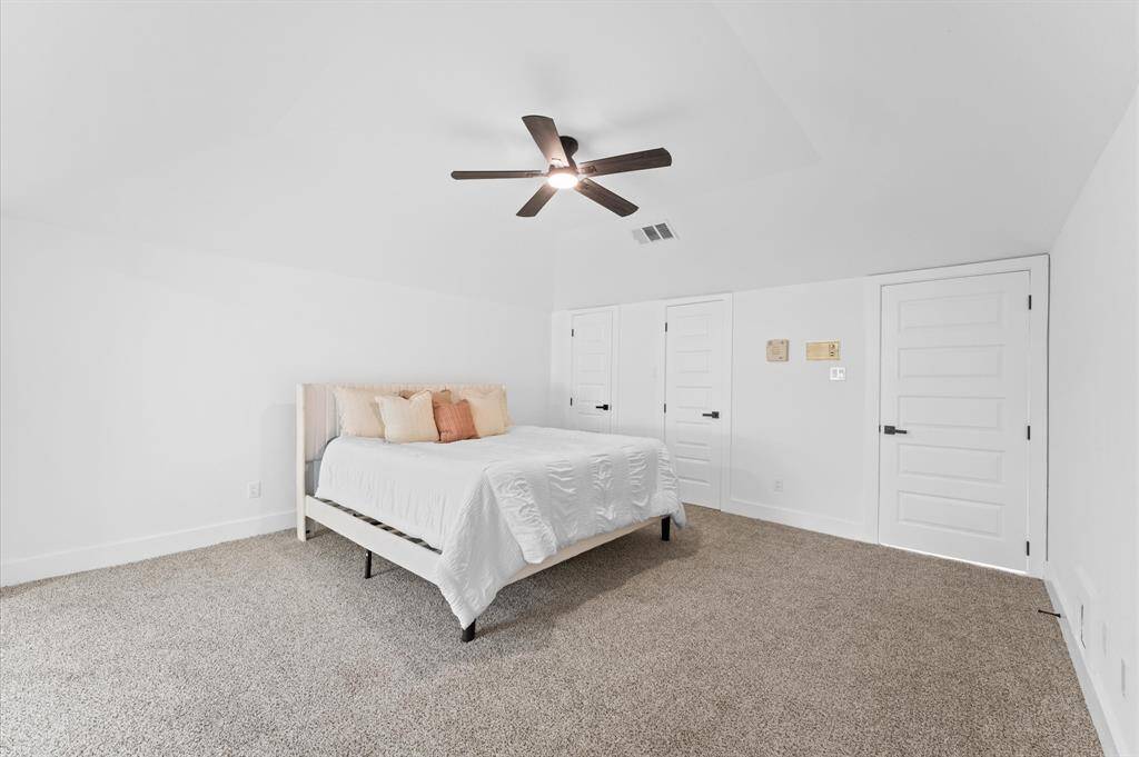 Expansive primary suite featuring a cozy sitting area with backyard access and plenty of natural light.