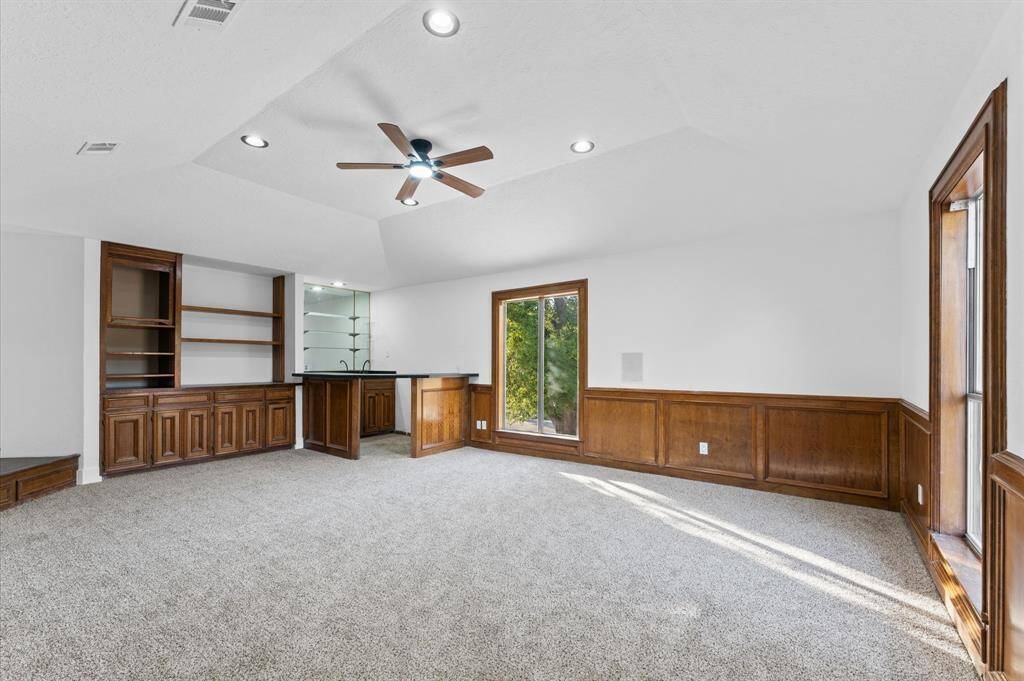 Large upstairs game room with a built-in wet bar, perfect for entertainment and relaxation.