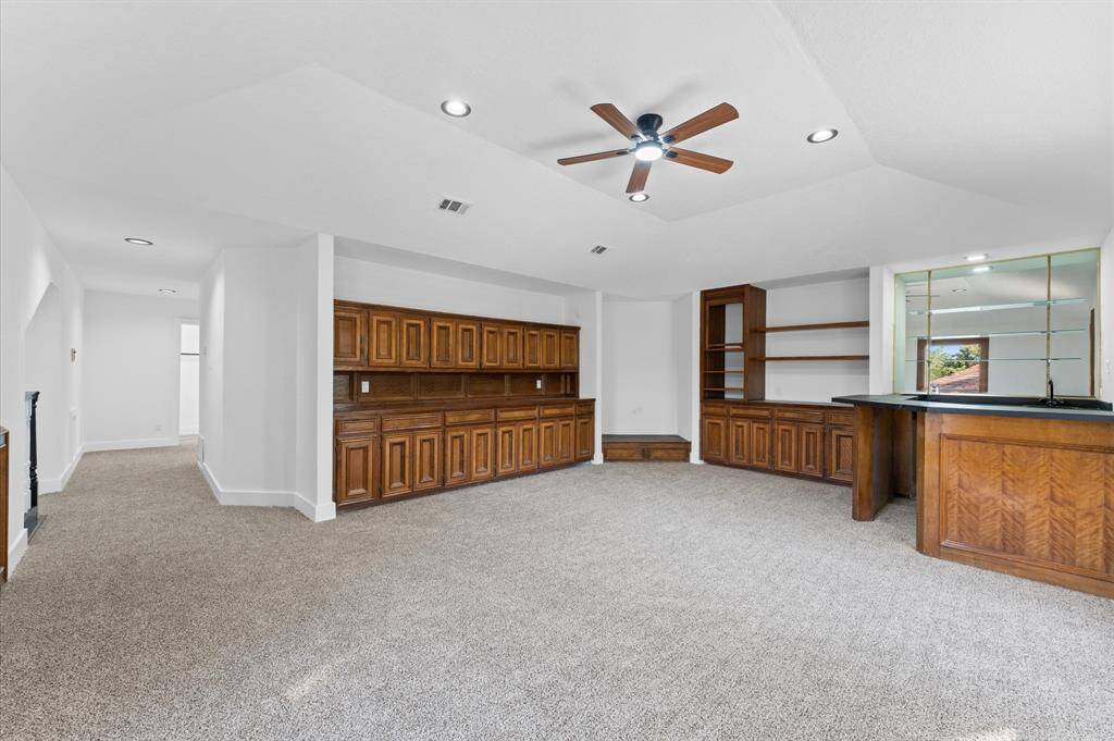 Large upstairs game room with a built-in wet bar, perfect for entertainment and relaxation.