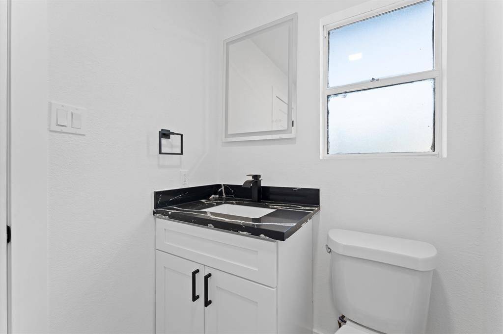Stylish half bath conveniently located for guests.