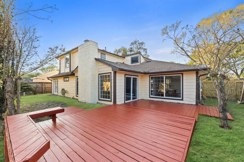Spacious backyard with plenty of room for outdoor activities and gatherings, accessible from the primary suite and living room.