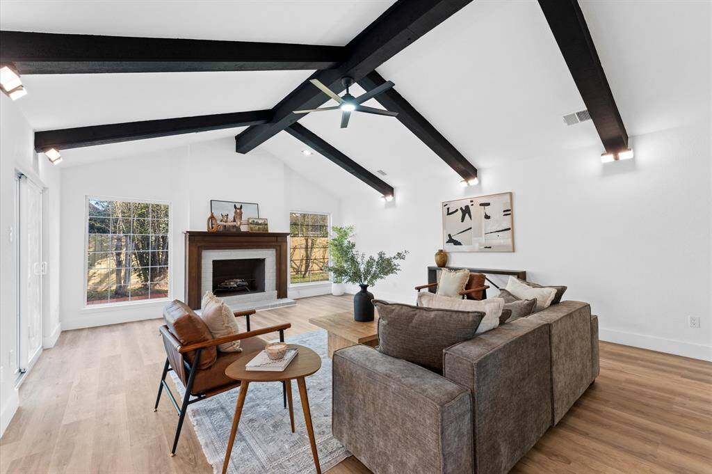 Stunning living area with soaring cathedral ceilings, abundant natural light, and an open-concept design perfect for entertaining.