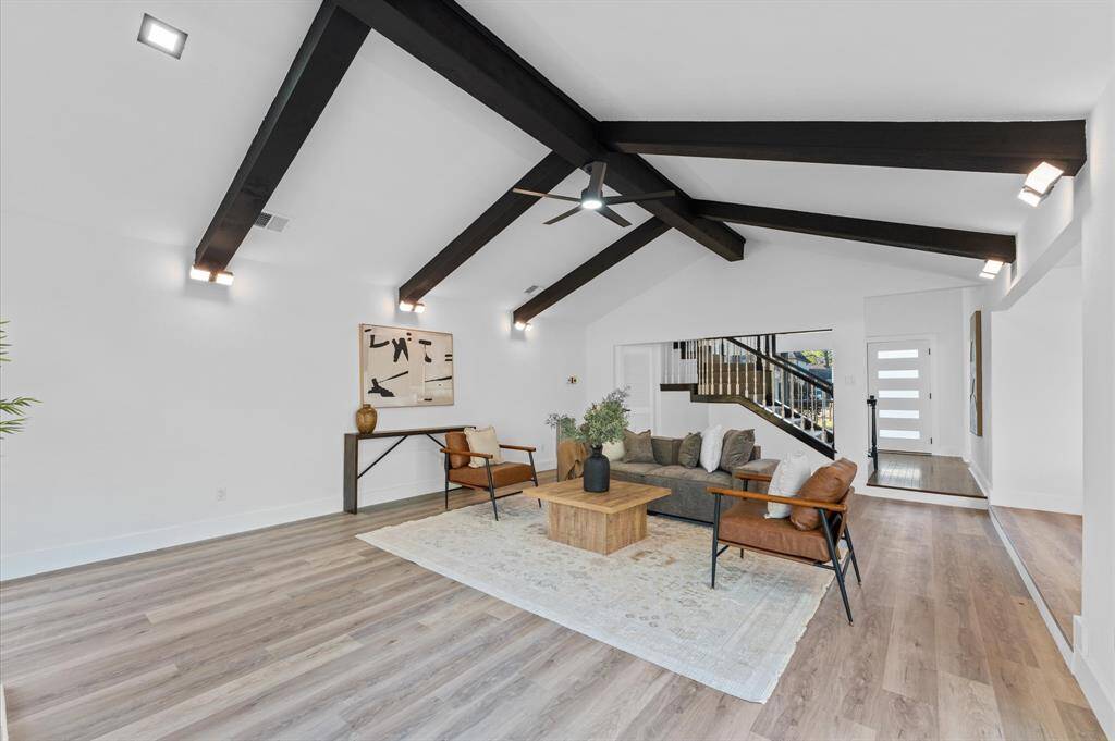 Living room has new flooring an abundance of natural light, creating a bright and inviting atmosphere.
