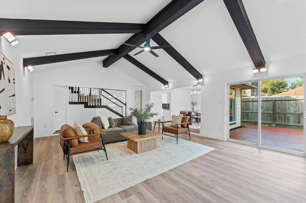 Living room has new flooring an abundance of natural light, creating a bright and inviting atmosphere.