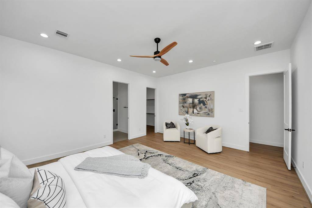 The primary bedroom has recessed lighting, ceiling fan, an en-suite bathroom, and walk-in closet.
