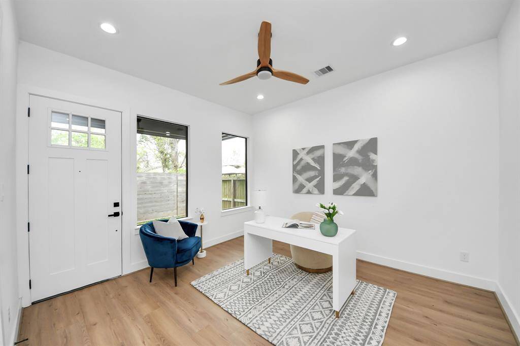 Third bedroom features large windows, ceiling fan, and recessed lighting. This backdoor leads you to a side yard and covered patio coming off of the secondary bedroom.