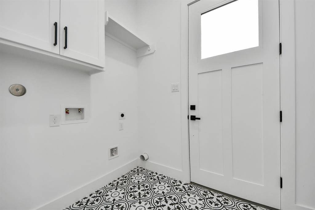 The laundry room features tile floors,washer and dryer connections, andplenty of storage space.