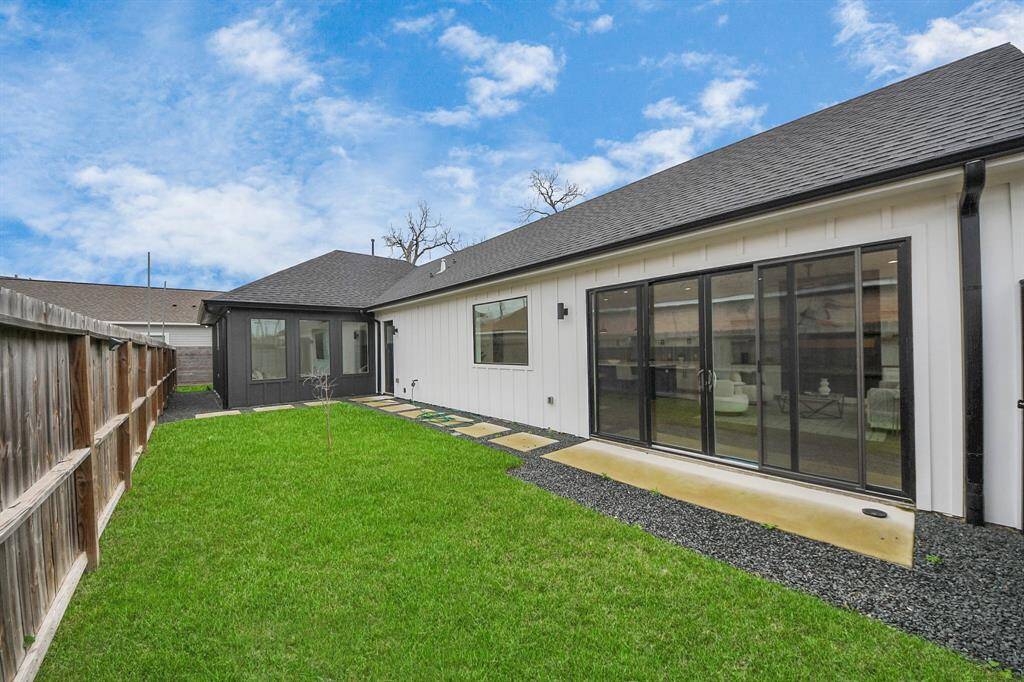 The yard has paving stones and plenty of green space.