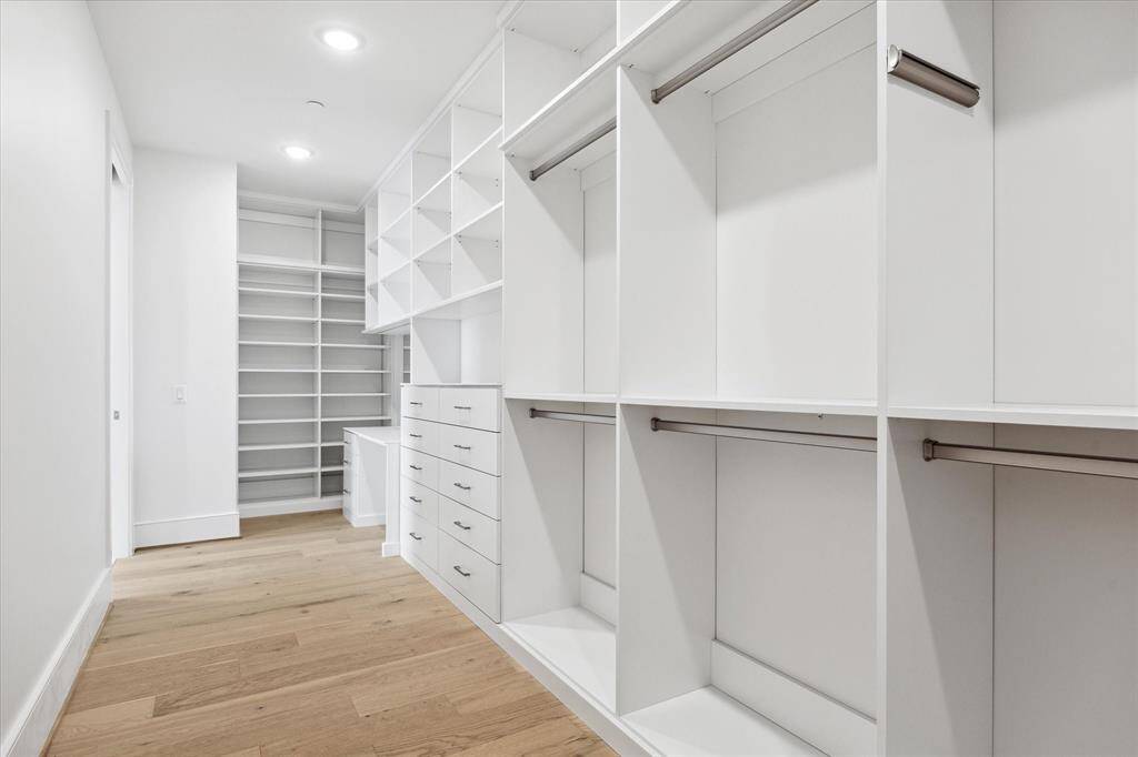 Upgraded custom primary closet with built-in shelves, hanging racks, and clothing drawers, and velvet-lined jewelry drawers.  Luxurious!