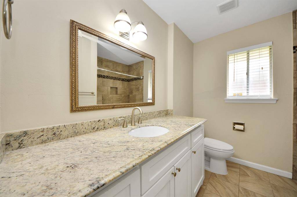 Updated secondary restroom with plenty of counter space