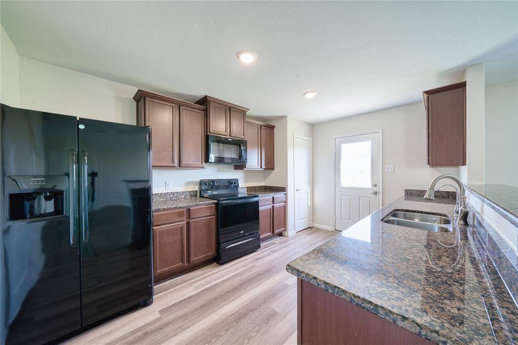 Kitchen with all Black Kitchen Appliances.